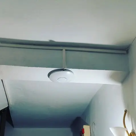 Οικιακό router Wi‑Fi πάνω σε γραφείο με φόντο σπίτι